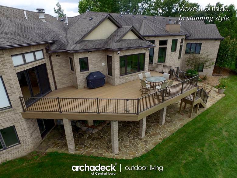 A large house with a deck and a lawn

AI-generated content may be incorrect.